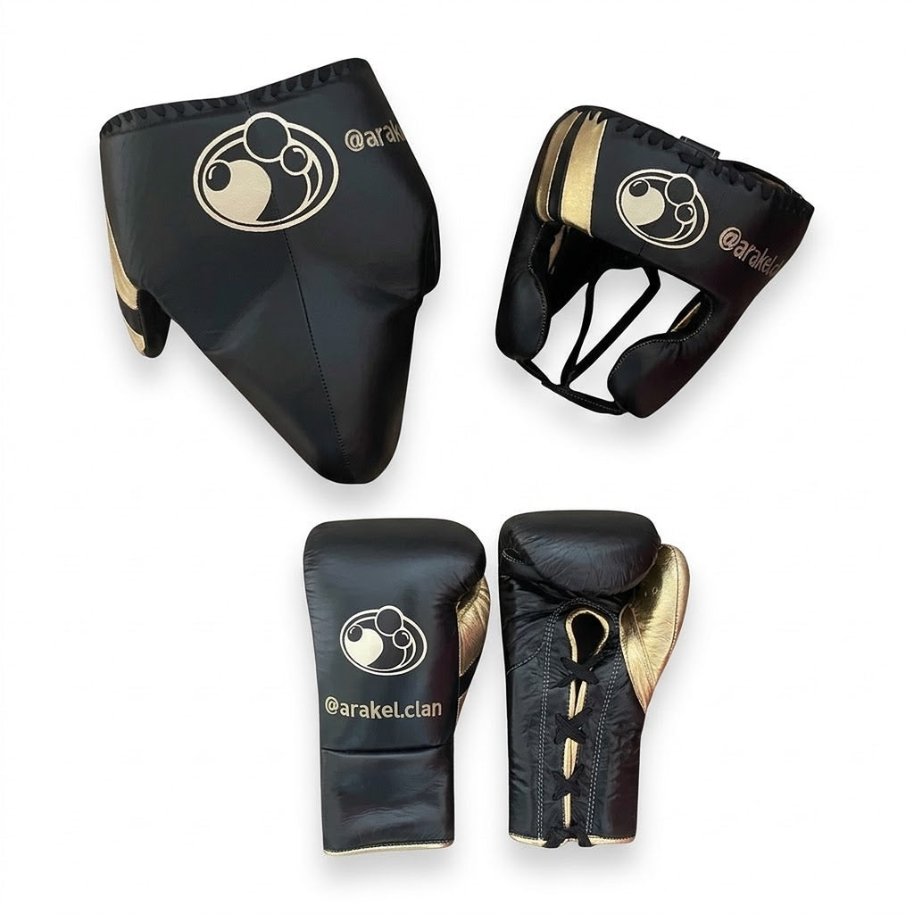 Grant black lace-up gloves with gold palms beside matching black and gold headgear and groin guard