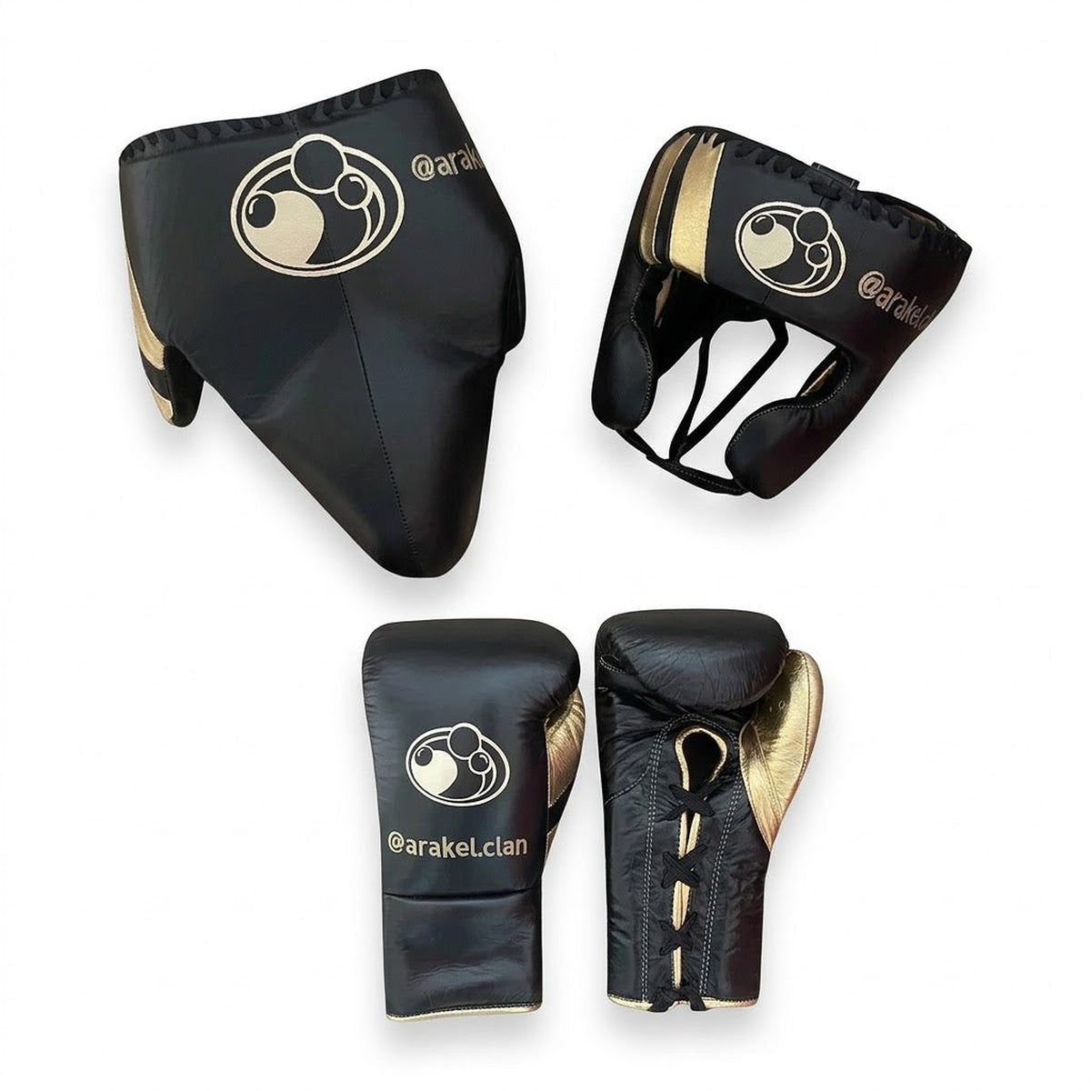 Grant black lace-up gloves with gold palms beside matching black and gold headgear and groin guard