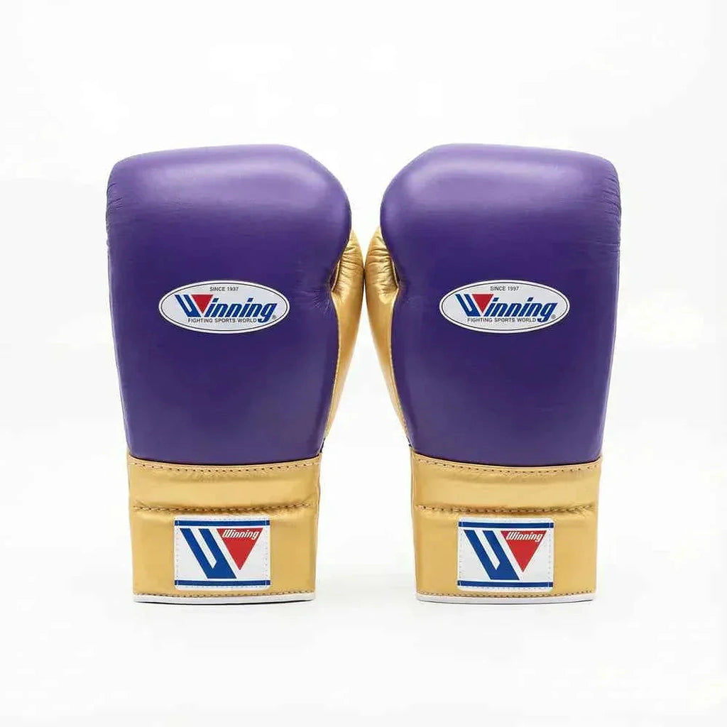 Winning lace-up boxing glove in purple leather with a gold cuff at the wrist