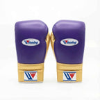 Winning lace-up boxing glove in purple leather with a gold cuff at the wrist