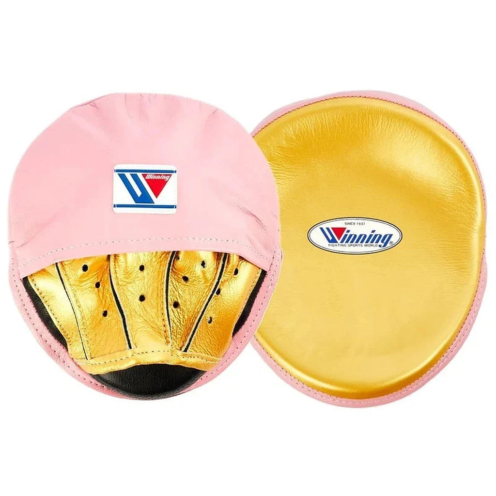 Winning pink curved focus mitts with shiny metallic gold grip on the palm side, shown as a matched pair - side view